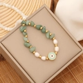 Macro shot of evil eye pendant bracelet with green stone beads and pearls on gift box - 3# Green Imperial Stone