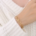Minimalist gold-plated hollow oval link bracelet worn on a white knit sweater background - Gold Oval Hollow Chain Bracelet-E305