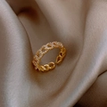 Golden chain style ring featuring clear sparkling stones on premium beige silk fabric - Gold Style B Twist