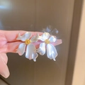 Detailed view of floral pearl earrings with golden centers held by hand for display - White Flower Gold Center Earrings / 5# Silver Earring Post - Silver