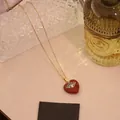 Collana dorata con ciondolo a cuore rosso e occhio greco in stile bohémien - Pietra Rossa