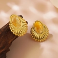Vintage golden starfish earrings with amber resin center on dark wooden stand - Gold Vintage Yellow Heart