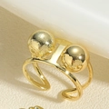 Close-up of golden adjustable ring with dual beads featuring polished and brushed texture - Double Bead Ring