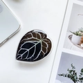 Macro detail of leaf-shaped phone grip with realistic green plant vein pattern on white desk - Leaf Holder - Style 5