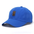 Close-up of breathable mesh fabric and brown leather patch on the blue sports cap - Blue