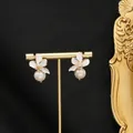 Elegant four-petal white flower earrings with zircon centers and white pearls on gold frame - Four-Petal White Flower Style