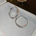 Detailed view of silver triple-layered interwoven hoop earrings in a gray jewelry box - Silver Three-interwoven Hoop Style (21#)