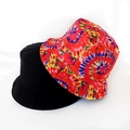 Close-up of dual-sided bucket hat featuring black solid fabric and psychedelic tie-dye print - Spiral Tie Dye
