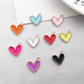 Close-up of colorful enamel heart pendants with gold alloy beads for DIY jewelry making - Multicolor