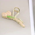 Detail of elegant gold tulip hair claw clip with pink enamel petals and green leaf accents - Enamel Dusty Pink Tulip / Bulk Packaging
