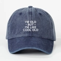 Detailed view of blue washed cotton baseball cap with white printed I'M OLD COOL OLD slogan - One Size / Navy Blue