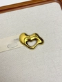 Close-up of golden irregular heart brooch on beige linen fabric with aesthetic card - 34 Gold Irregular Hollow (XZ0024)