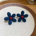 Detailed close-up of navy blue flocked flower earrings with a red center on a beige cushion - 27# Silver Earring Post - Blue - Flower