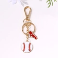 Baseball keychain featuring a red shoe and white ball charm with a golden metal clasp - Gold Baseball Red Shoe Style