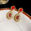 Detail of vintage court style earrings with red oval stones and gold metal framing - Gold-Red (Silver Needle)
