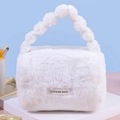 White plush cosmetic bag with unique spherical handle and soft faux fur texture - White