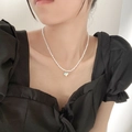 Elegant pearl necklace featuring a colorful iridescent heart pendant on a model - 5902869302608 / Iridescent Heart Pearl Necklace (X1992) / Iridescent/Pearl White