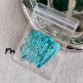 Set of five teal sequin drop-shaped snap hair clips in transparent retail packaging - Green Waterdrop