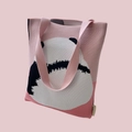 Detail of pink knitted tote bag with cute panda pattern and woven brand label - Pink Panda Back