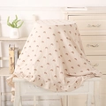 Detailed texture of cotton muslin baby blanket with rainbow prints and ruffled edge - Grey Rainbow