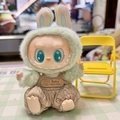 Labubu doll outfit featuring green plush hat and brown knit overalls with yellow chair - Brown Bear Bubble Overalls / First And Second Generation Keychains Are Compatible With La Cloth Dolls. Dolls Not Included.