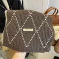 Detail of soft knit plaid scarf in dark brown with white diamonds and hand made tag - Brown