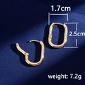 Minimalist gold U-shaped oval hoop earrings shown open and closed on a blue background - Oval Geometric / Gold