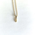 Detailed top view of a minimalist gold necklace with a sleek rectangular pendant on white - Letter I