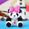 Detail of a cute panda plush pendant with a large pink bow and star-filled necklace. - Bowtie Panda / Pink / 12cm