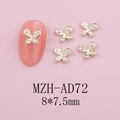 Macro shot of 8x7.5mm gold butterfly nail charms with rhinestones on pink nails - Gold Rhinestone Butterfly (AD72)