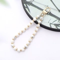 Detail of white turquoise beaded phone strap with gold lobster clasp and spacers - K3417 White Turquoise Natural Stone Pendant