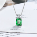 Macro shot of rectangular emerald-cut green gemstone pendant with silver chain - Green Zirconia