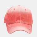 Close-up of pink distressed baseball cap with white contrast stitching and frayed edges - Watermelon red