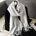Detail view of the soft fringed hem on a gray-white cashmere-feel scarf draped on a mannequin - Off-White