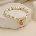 Beaded bracelet with white pearls, gold copper beads and pink crown enamel charm on stone - Pink Simple Crown Pendant