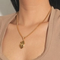 Close-up of a gold anatomical heart pendant necklace featuring a twisted rope chain - 3D Anatomical Heart Pendant / Small Gold