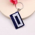Blue and white cassette tape keychain with 1990 FRIEND text on minimalist beige base - Blue