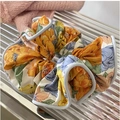 Floral print scrunchie with yellow and blue flowers and light blue border piping - Orange Yellow Floral