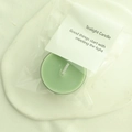 Single green scented tea light candle in minimalist clear packaging with white card tag - Willow Green (Pomelo Green Tangerine)