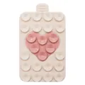 Detailed view of dual-color silicone suction pad with pink heart pattern and hanging hole - Light Pink & Pink