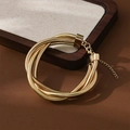 Detailed view of golden multi-layer snake chain bracelet with lobster clasp and extender - Gold Wound Bracelet