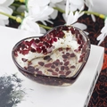 Heart-shaped resin dish with red crystals and gold foil on decorative book - 19 Garnet + Gold Foil