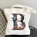 Detailed view of canvas tote bag featuring floral alphabet B print on a metal chair - Letter B / 35*40cm