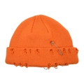 Close-up of orange distressed knit beanie with metal safety pin and ring details - Adjustable / Orange