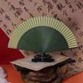 Classic Chinese green folding fan with bamboo carving and metal chain pendant - 42 Square Green