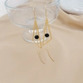 Detail of long gold geometric triangle earrings with black beads and fine chain tassels - CEK245 Geometric Triangle Black Bead Tassel Earrings