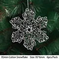 Transparent acrylic 95mm snowflake Christmas ornaments hanging on a festive green tree - 95mm Cotton Snowflake