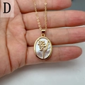Detail of oval mother of pearl shell pendant with golden floral lily of the valley motif - Style D