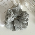 Detail of white mesh scrunchie with black polka dots on a minimalist aesthetic background - White Polka Dot