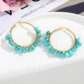 Macro detail of handmade bohemian round hoop earrings with green turquoise and gold wire - Turquoise Green